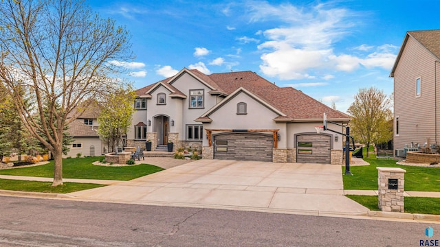 5604 S Jersey Tess Dr, Sioux Falls, SD 57108 - view of front of property featuring stone siding, stucco siding, a front lawn, and driveway