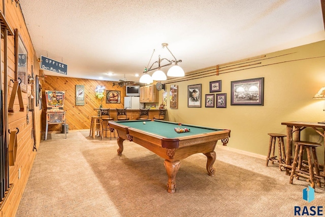 recreation room featuring billiards, wood walls, carpet, and baseboards