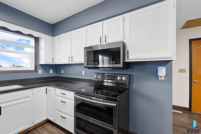 46902 284th St, Lennox, SD 57039 - kitchen featuring dark wood-style floors, stainless steel appliances, white cabinetry, and dark countertops