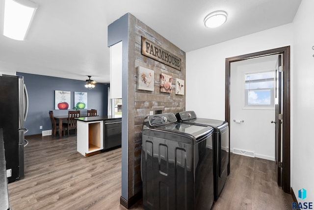 46902 284th St, Lennox, SD 57039 - clothes washing area with a ceiling fan, washing machine and dryer, visible vents, wood finished floors, and laundry area