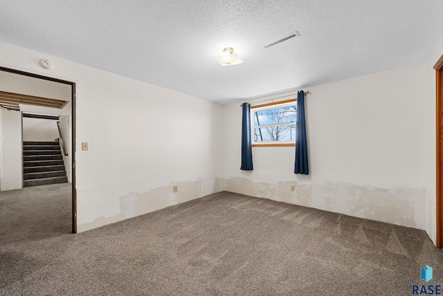 46902 284th St, Lennox, SD 57039 - carpeted empty room featuring stairway, a textured ceiling, and visible vents