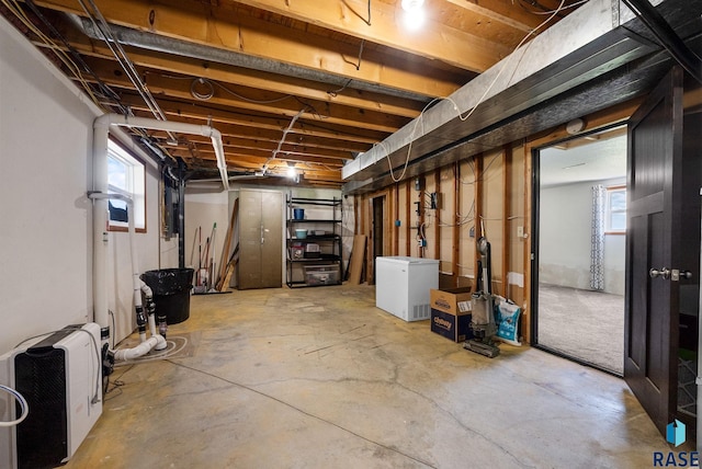 46902 284th St, Lennox, SD 57039 - below grade area with refrigerator, heating unit, and plenty of natural light