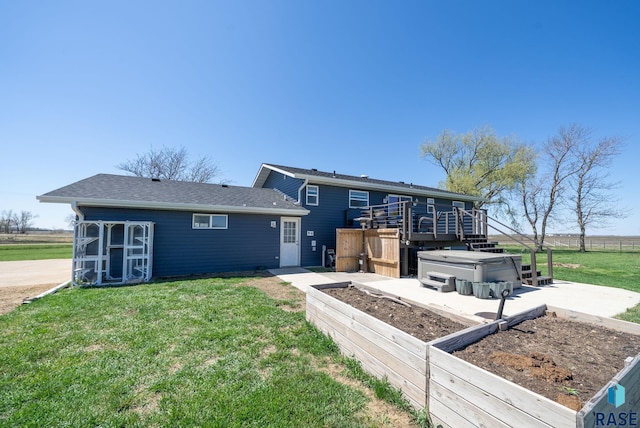 46902 284th St, Lennox, SD 57039 - back of house with a hot tub, fence, a wooden deck, a lawn, and a vegetable garden