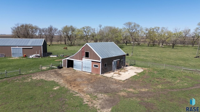 46902 284th St, Lennox, SD 57039 - view of pole building featuring fence, dirt driveway, a lawn, and an exterior structure