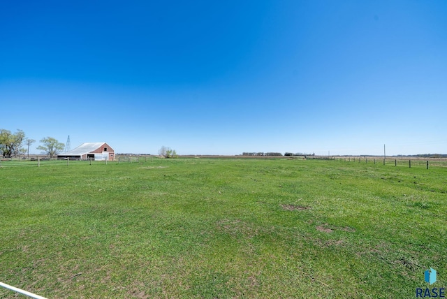 46902 284th St, Lennox, SD 57039 - view of yard featuring fence, a rural view, an outbuilding, and a barn