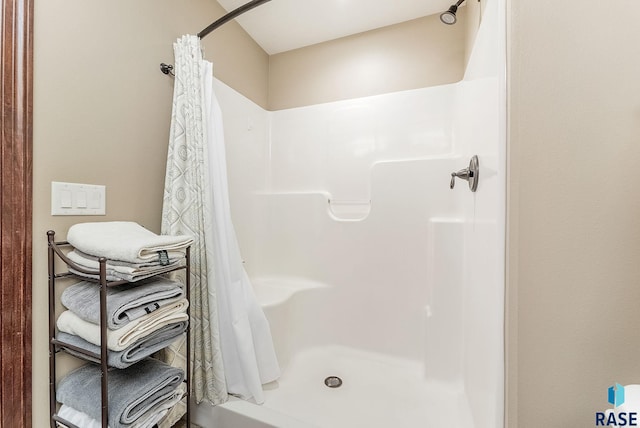 bathroom with a shower stall