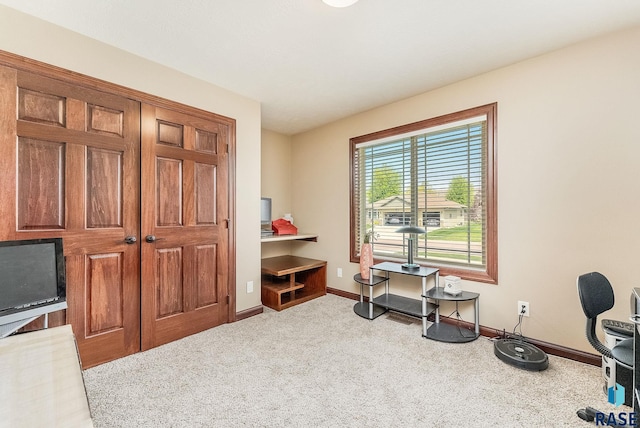 misc room featuring baseboards, carpet, and an office area