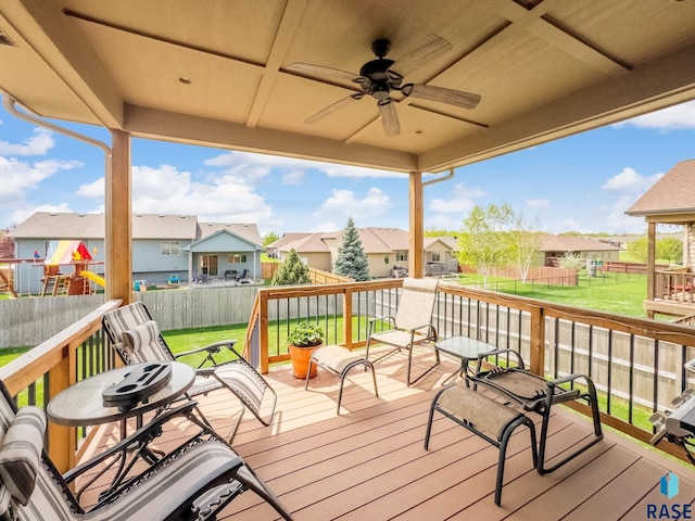 wooden terrace with a residential view and ceiling fan