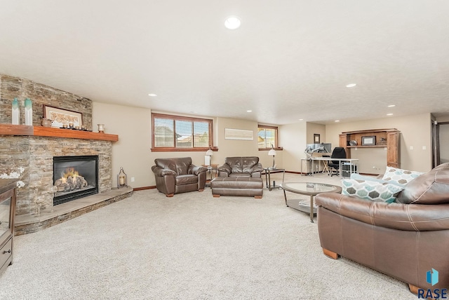living area featuring a stone fireplace, recessed lighting, carpet floors, and baseboards