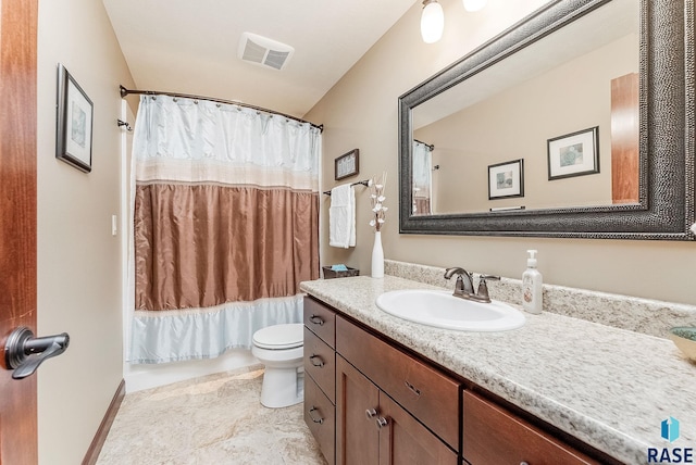 bathroom with toilet, vanity, and shower / bath combo