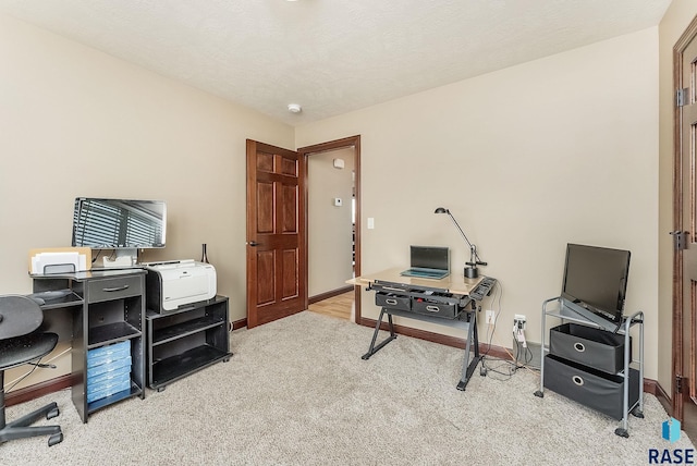 home office with carpet floors and baseboards