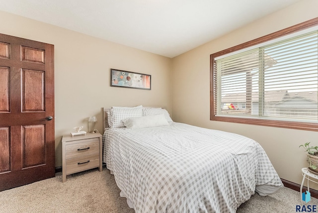 bedroom featuring light carpet