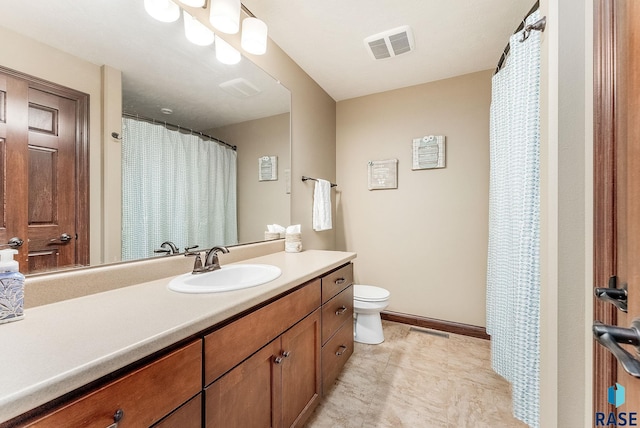 full bathroom featuring vanity, toilet, and baseboards