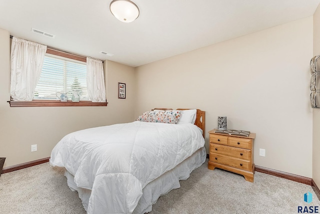 carpeted bedroom featuring baseboards