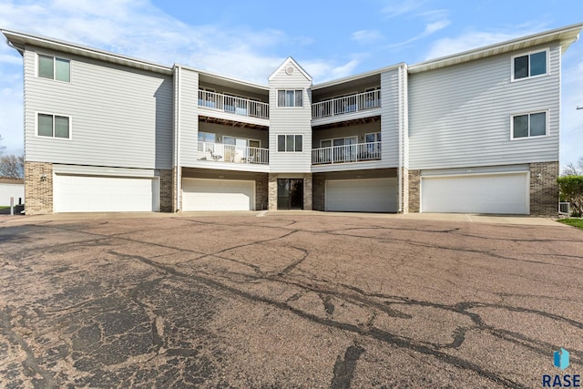 4601 S Oxbow Ave Unit 301, Sioux Falls, SD 57106 - view of front of home featuring brick siding, driveway, and a garage