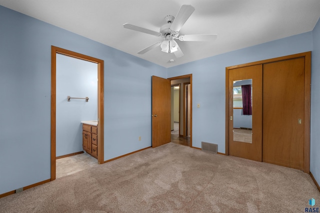 unfurnished bedroom with a closet, visible vents, light carpet, a ceiling fan, and baseboards