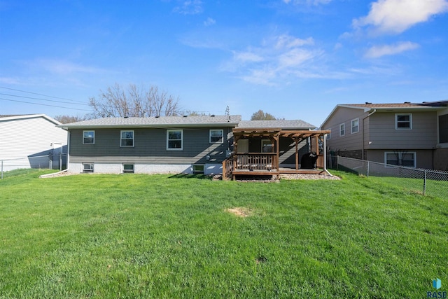 rear view of house featuring a lawn, a gazebo, a wooden deck, and a fenced backyard