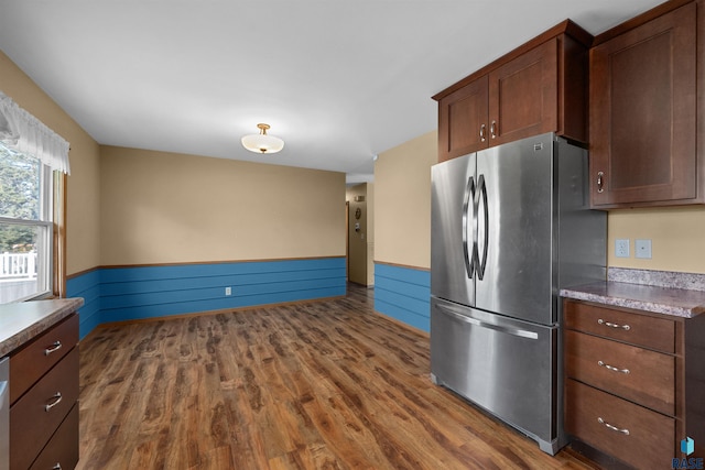 kitchen with freestanding refrigerator and dark wood-style flooring