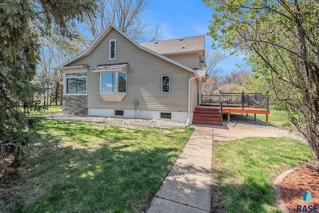 view of property exterior with a wooden deck and a lawn