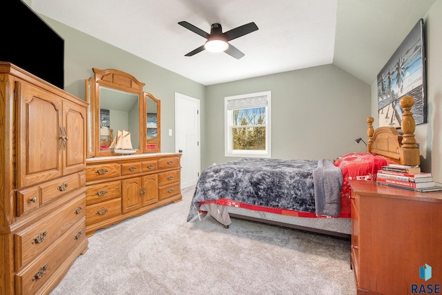 bedroom featuring light colored carpet, lofted ceiling, and ceiling fan