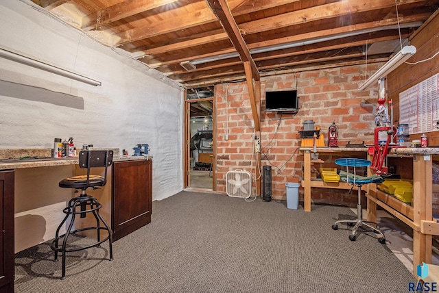 unfinished below grade area featuring a workshop area and carpet
