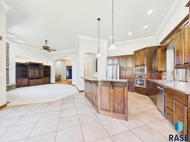 6204 S Doral Trl, Sioux Falls, SD 57108 - kitchen featuring stainless steel appliances, a sink, arched walkways, a breakfast bar area, and ceiling fan