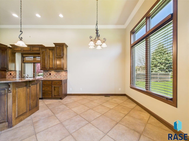 6204 S Doral Trl, Sioux Falls, SD 57108 - kitchen featuring a chandelier, decorative backsplash, ornamental molding, light tile patterned floors, and decorative light fixtures