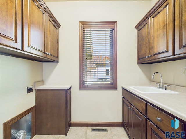 6204 S Doral Trl, Sioux Falls, SD 57108 - clothes washing area featuring cabinet space, hookup for an electric dryer, and baseboards