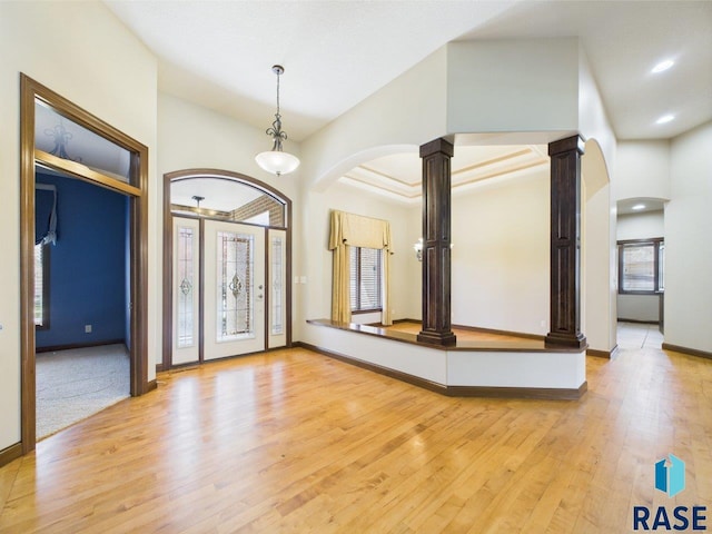 6204 S Doral Trl, Sioux Falls, SD 57108 - foyer featuring arched walkways, ornate columns, healthy amount of natural light, and light wood-style floors