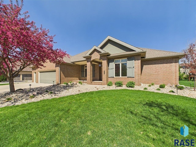 6204 S Doral Trl, Sioux Falls, SD 57108 - ranch-style home with a garage, a front lawn, brick siding, and driveway