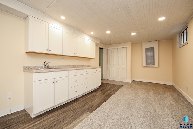 kitchen with light countertops, recessed lighting, a sink, and electric panel