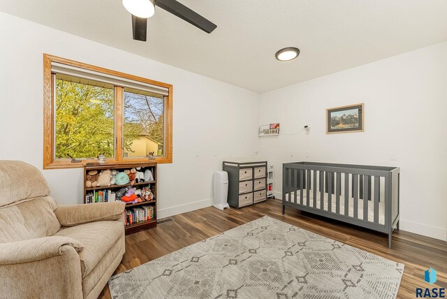 bedroom featuring ceiling fan, baseboards, and wood finished floors