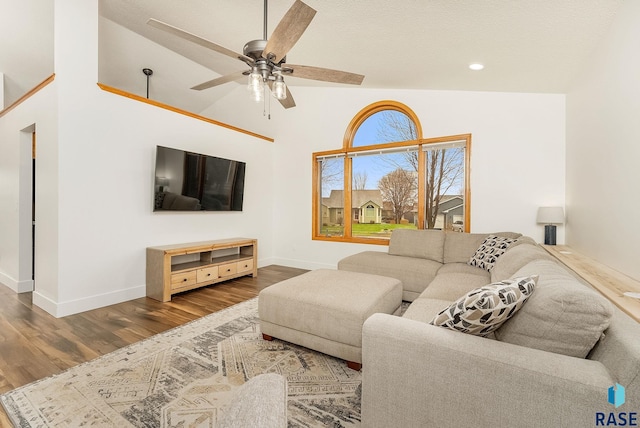 living area with wood finished floors, high vaulted ceiling, recessed lighting, ceiling fan, and baseboards