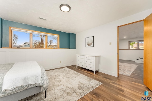 bedroom featuring visible vents, wood finished floors, and baseboards