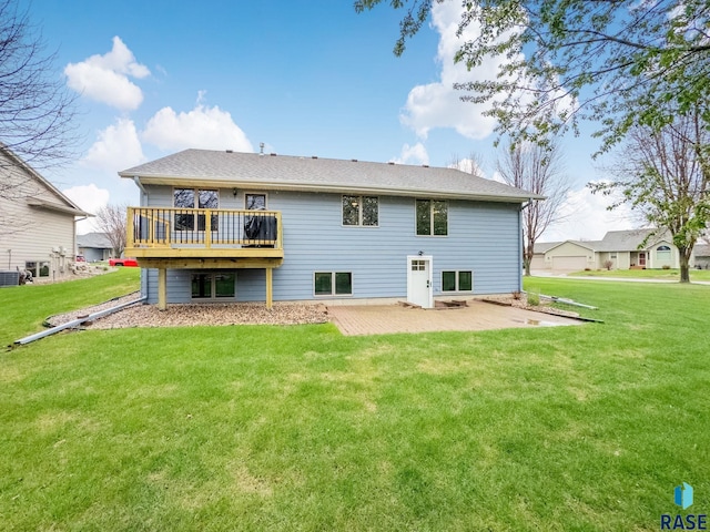 rear view of property featuring a lawn, a patio area, a wooden deck, and cooling unit