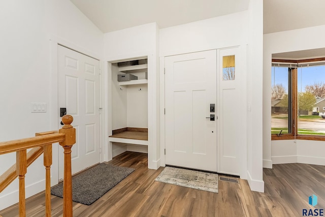 entrance foyer with visible vents, wood finished floors, and baseboards