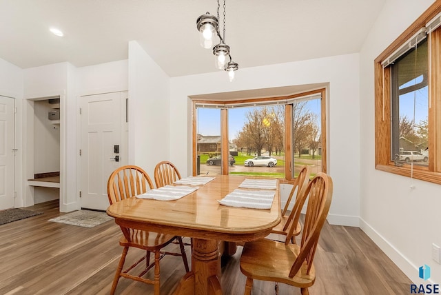 dining area featuring baseboards and wood finished floors