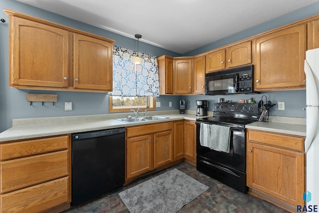 kitchen with a sink, pendant lighting, stone finish floor, black appliances, and light countertops