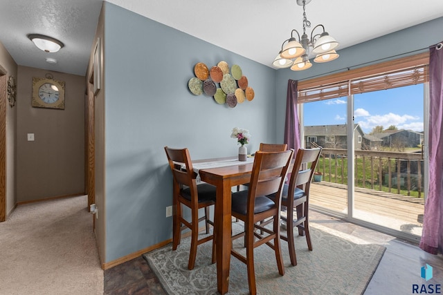 dining space with a chandelier and baseboards