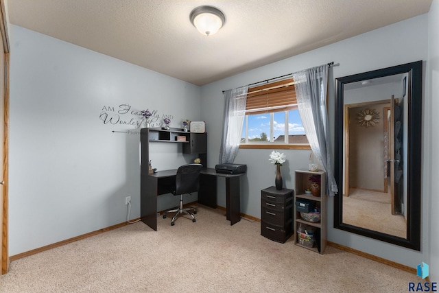 carpeted office space featuring baseboards