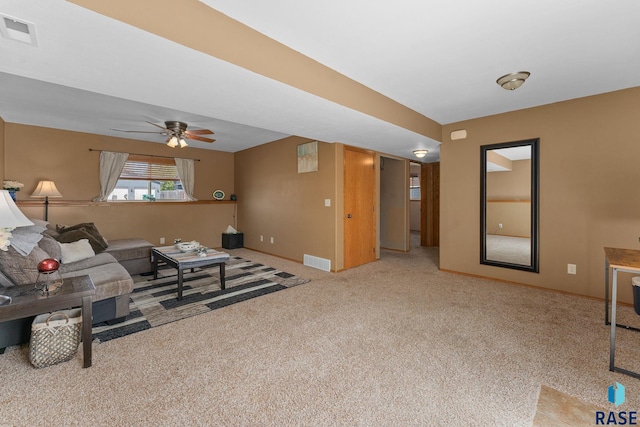 living room featuring carpet flooring, visible vents, baseboards, and ceiling fan