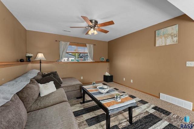 carpeted living area featuring baseboards, a ceiling fan, and visible vents