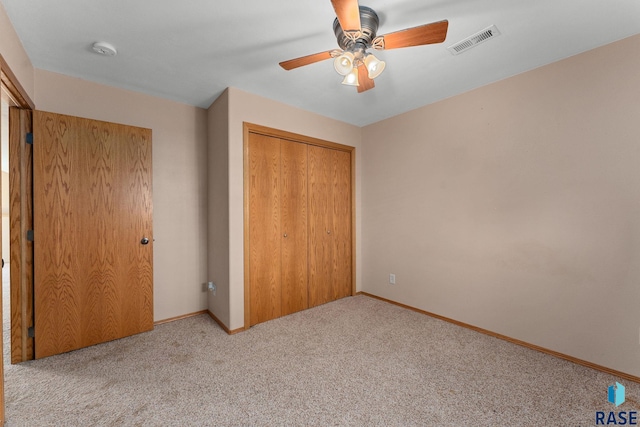 unfurnished bedroom featuring a closet, visible vents, carpet floors, a ceiling fan, and baseboards