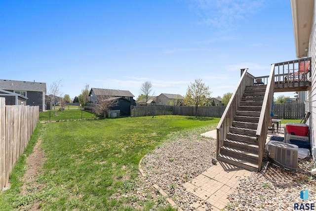 view of yard featuring a fenced backyard and stairs