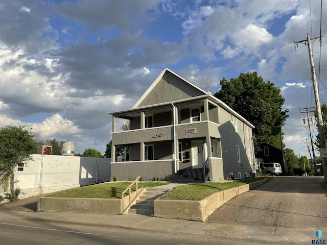 207 W 14th St, Sioux Falls, SD 57104 - townhome / multi-family property featuring fence, stucco siding, and a balcony