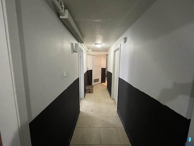 207 W 14th St, Sioux Falls, SD 57104 - hall with a textured ceiling, a textured wall, and light tile patterned floors
