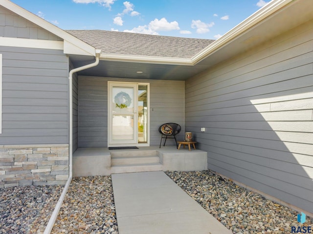 property entrance with roof with shingles