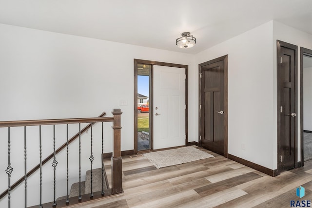 entryway featuring baseboards and light wood-type flooring
