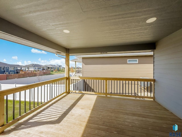deck with fence and a residential view