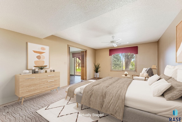 carpeted bedroom with a textured ceiling and a ceiling fan